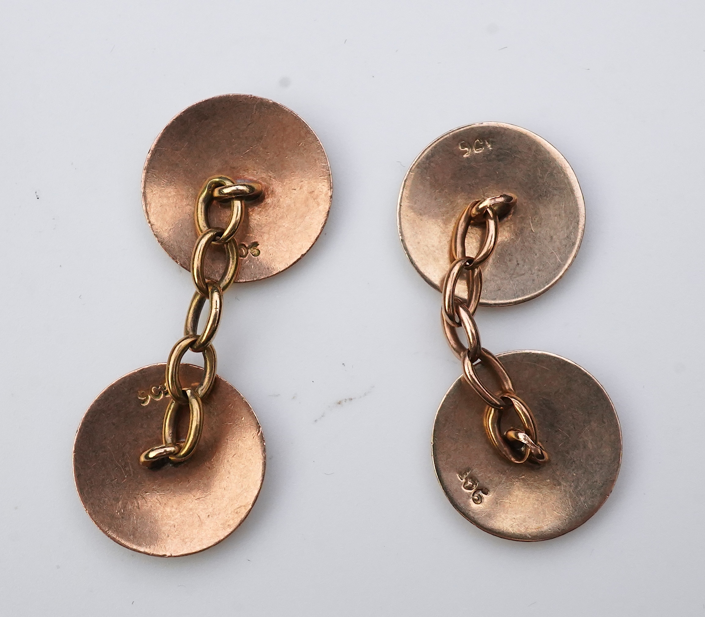 A pair of gold and enamel cufflinks